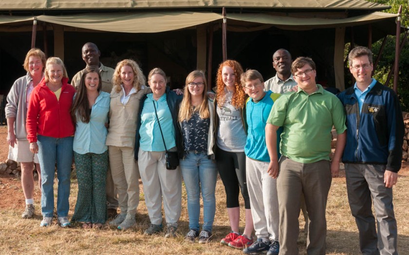 Safari group photo: Peggy, Amy, Erin, Doe, Pam, Mara, Isabel, Andy, John, David; with guides Robert and Freddy in back. At Serengeti East nyumba, Enashiva Reserve, last morning of the safari.